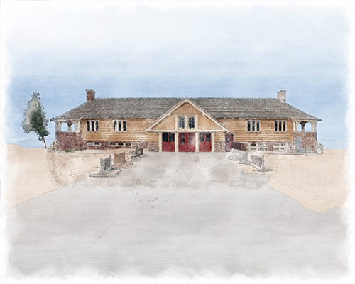 Beach House seen from the dunes, framed by sand and pines, warm light softening its historic stone.